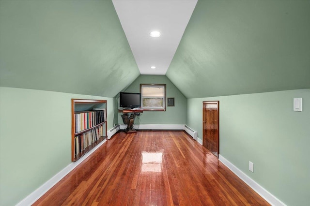 4520 Merrick Rd, Massapequa, NY 11758 - bonus room with wood finished floors, vaulted ceiling, a baseboard radiator, baseboards, and a baseboard heating unit