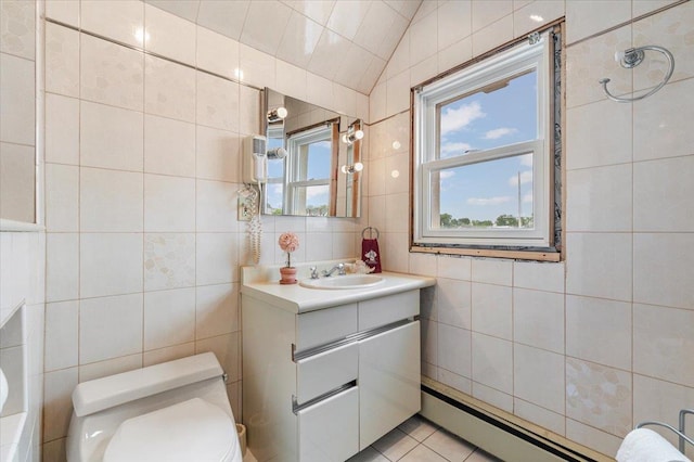 4520 Merrick Rd, Massapequa, NY 11758 - bathroom featuring tile walls, toilet, vanity, a baseboard heating unit, and vaulted ceiling