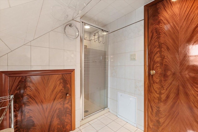 4520 Merrick Rd, Massapequa, NY 11758 - bathroom featuring tile walls, tile patterned flooring, and a stall shower