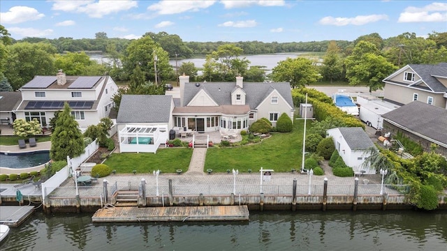 4520 Merrick Rd, Massapequa, NY 11758 - back of property with a sunroom, a water view, a chimney, and a patio area