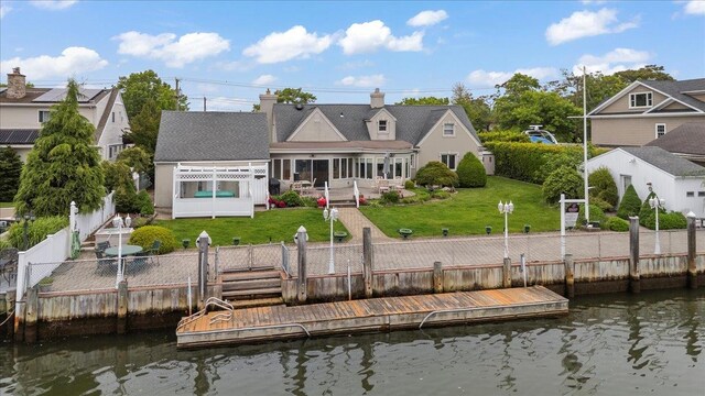 4520 Merrick Rd, Massapequa, NY 11758 - back of property with a patio, a chimney, and a deck with water view