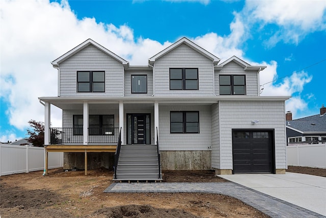 482 S 5th St, Lindenhurst, NY 11757 - view of front facade featuring a porch, an attached garage, driveway, and stairway