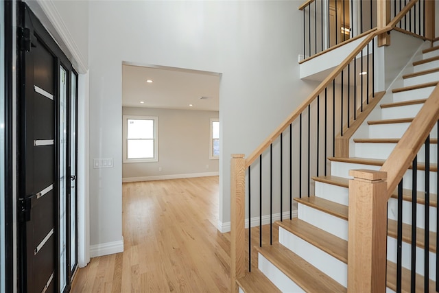 482 S 5th St, Lindenhurst, NY 11757 - entrance foyer featuring wood finished floors, stairs, baseboards, a towering ceiling, and recessed lighting
