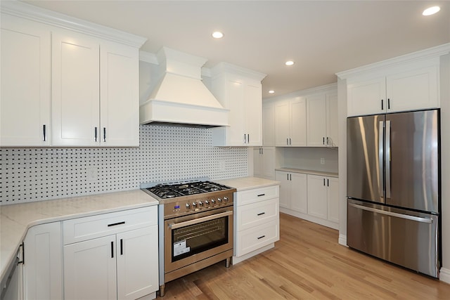 482 S 5th St, Lindenhurst, NY 11757 - kitchen with appliances with stainless steel finishes, premium range hood, white cabinetry, decorative backsplash, and recessed lighting