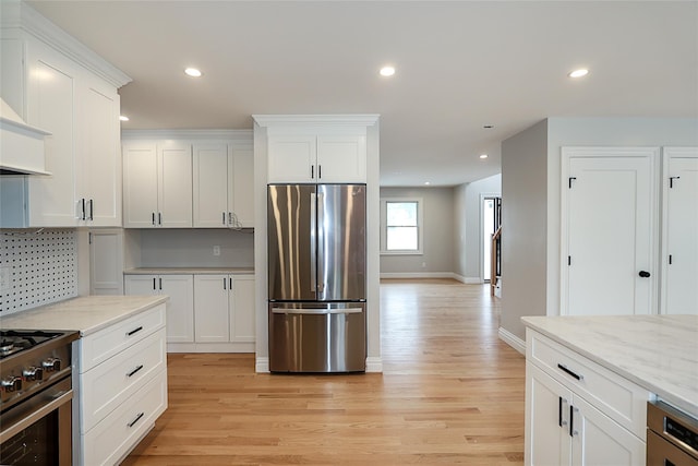 482 S 5th St, Lindenhurst, NY 11757 - kitchen featuring stainless steel appliances, light wood-style flooring, white cabinets, baseboards, and recessed lighting