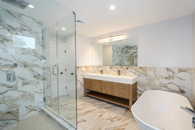 482 S 5th St, Lindenhurst, NY 11757 - bathroom featuring tile walls, marble tiled flooring, a marble finish shower, a soaking tub, and recessed lighting