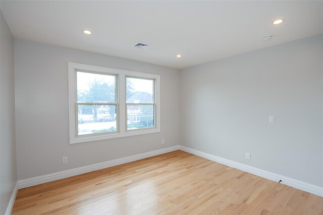 482 S 5th St, Lindenhurst, NY 11757 - empty room with wood finished floors, recessed lighting, baseboards, and a smoke detector