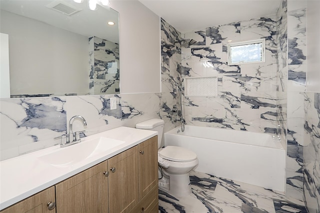 482 S 5th St, Lindenhurst, NY 11757 - bathroom with tile walls, toilet, marble tiled floors, vanity, and tub / shower combination