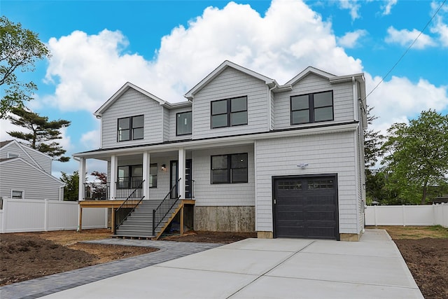 482 S 5th St, Lindenhurst, NY 11757 - view of front of home with covered porch, an attached garage, and driveway