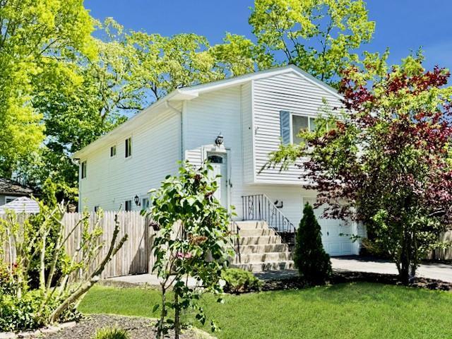 10 Brushwood Dr, Shirley, NY 11967 - view of home's exterior with a garage