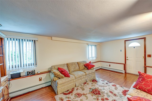 50 W Hampton Rd, Lindenhurst, NY 11747 - living area featuring a baseboard radiator, wood finished floors, and a textured ceiling