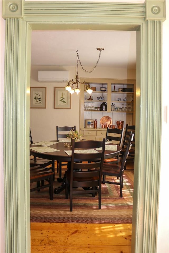 763 Old State Route 22, Dover Plains, NY 12522 - dining room featuring a wall mounted AC, light wood-type flooring, and a chandelier