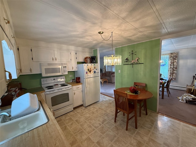 305 Brittany Ter Unit 305, Rock Tavern, NY 12575 - kitchen featuring white appliances, a sink, baseboard heating, white cabinets, and a textured ceiling