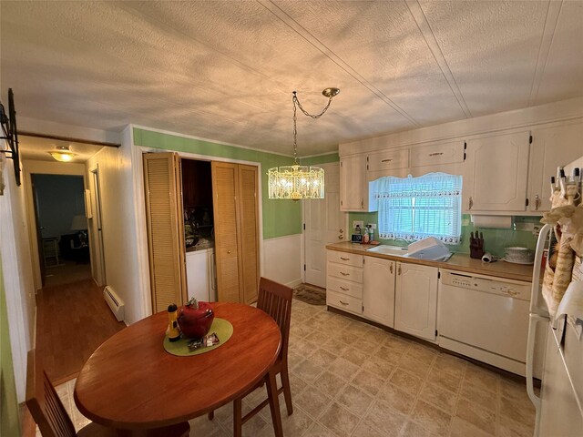 305 Brittany Ter Unit 305, Rock Tavern, NY 12575 - kitchen with baseboard heating, white appliances, white cabinetry, a chandelier, and a sink