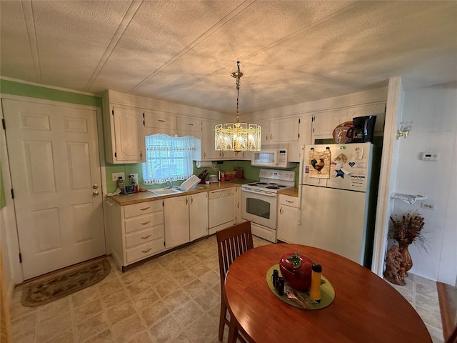 305 Brittany Ter Unit 305, Rock Tavern, NY 12575 - kitchen featuring white appliances, a chandelier, a sink, light flooring, and light countertops