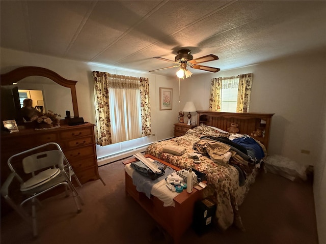305 Brittany Ter Unit 305, Rock Tavern, NY 12575 - carpeted bedroom with a baseboard heating unit, a ceiling fan, and multiple windows