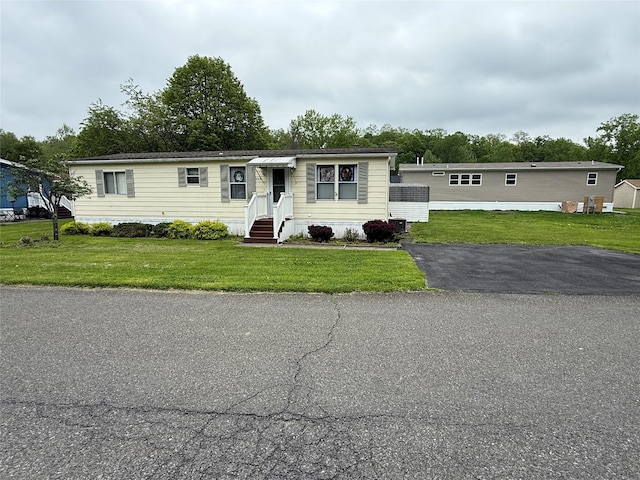 305 Brittany Ter Unit 305, Rock Tavern, NY 12575 - manufactured / mobile home featuring a front lawn and entry steps