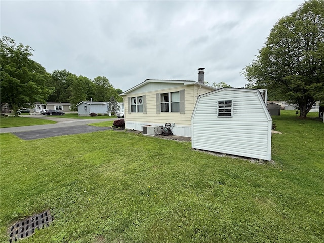305 Brittany Ter Unit 305, Rock Tavern, NY 12575 - view of side of property with a lawn and central air condition unit
