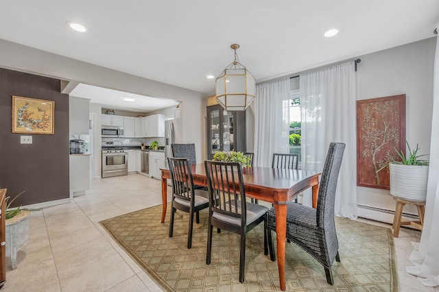 56 15th St, West Babylon, NY 11704 - dining area with light tile patterned floors, baseboard heating, recessed lighting, and baseboards