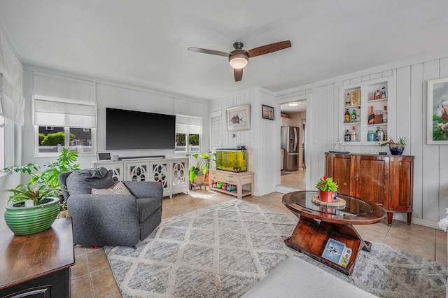 56 15th St, West Babylon, NY 11704 - living room with ceiling fan, light tile patterned flooring, and a decorative wall