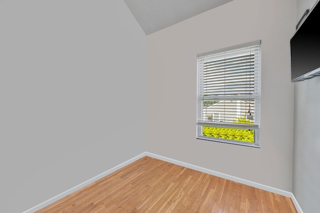 56 15th St, West Babylon, NY 11704 - empty room with baseboards, light wood-style flooring, and vaulted ceiling