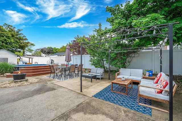 56 15th St, West Babylon, NY 11704 - fenced backyard featuring an outdoor living space with a fire pit, outdoor dining area, and a patio area