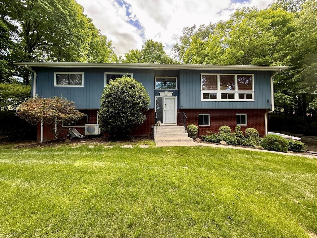 73 Wilder Rd, Suffern, NY 10901 - raised ranch featuring entry steps, a front yard, and brick siding