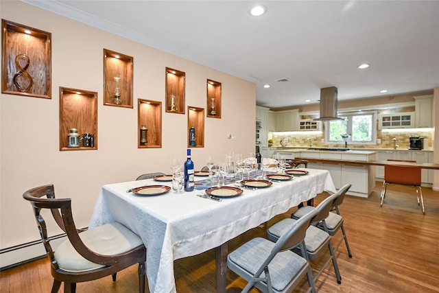 1608 Union Ave Unit 1608, Hewlett, NY 11557 - dining space featuring recessed lighting, crown molding, light wood-type flooring, and a baseboard radiator