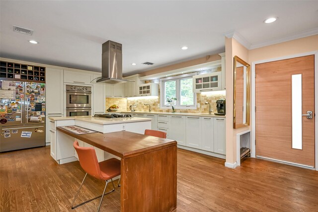 1608 Union Ave Unit 1608, Hewlett, NY 11557 - kitchen with stainless steel appliances, island range hood, a kitchen island, light countertops, and glass insert cabinets