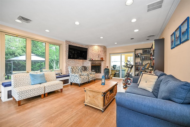 1608 Union Ave Unit 1608, Hewlett, NY 11557 - living room with crown molding, light wood-style floors, healthy amount of natural light, recessed lighting, and a brick fireplace