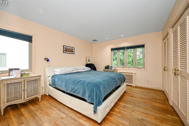 1608 Union Ave Unit 1608, Hewlett, NY 11557 - bedroom with radiator, light wood-style flooring, baseboards, and recessed lighting