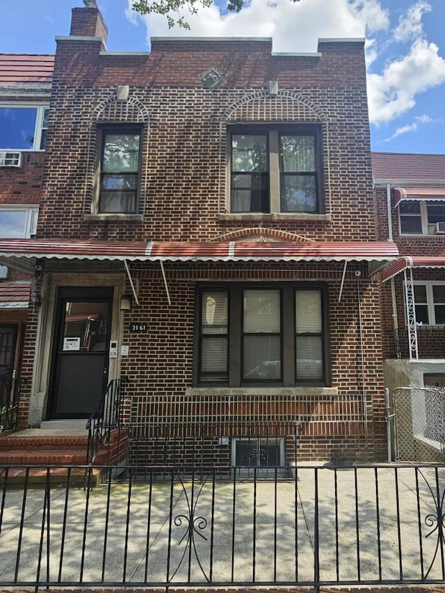 31-61 43rd St, Astoria, NY 11103 - view of front of property featuring brick siding and a fenced front yard