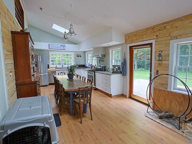 120 Spring Glen Rd, Mountain Dale, NY 12763 - dining space featuring vaulted ceiling, light wood-style floors, and wood walls