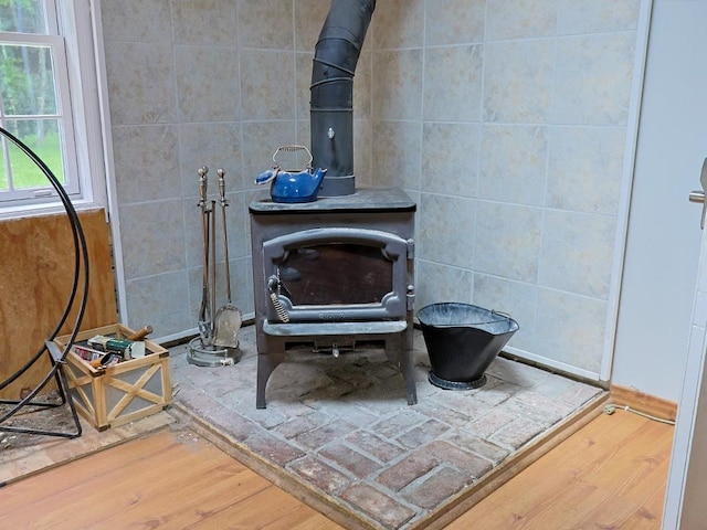 120 Spring Glen Rd, Mountain Dale, NY 12763 - detailed view of a wood stove, wood finished floors, and tile walls