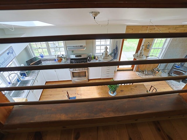 120 Spring Glen Rd, Mountain Dale, NY 12763 - kitchen view of white cabinetry, wood finished floors, dark countertops, and a wall unit AC