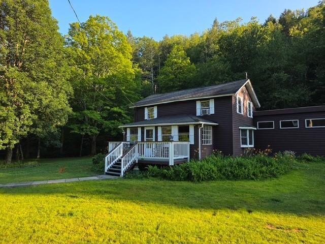 120 Spring Glen Rd, Mountain Dale, NY 12763 - view of front of property featuring a front lawn, covered porch, and a wooded view