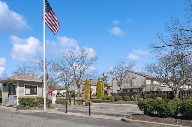 100 Daly Blvd Unit 2605, Oceanside, NY 11572 - view of asphalt road featuring traffic signs, curbs, and a residential view