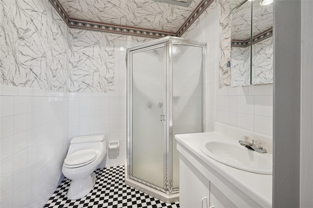 100 Daly Blvd Unit 2605, Oceanside, NY 11572 - bathroom featuring tile walls, a shower stall, vanity, and toilet