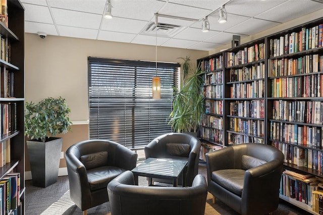 100 Daly Blvd Unit 2605, Oceanside, NY 11572 - sitting room with track lighting, wall of books, and carpet floors