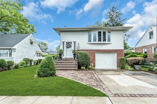1150 Langdon St, Franklin Square, NY 11010 - view of front of house featuring a front lawn, brick siding, driveway, and an attached garage
