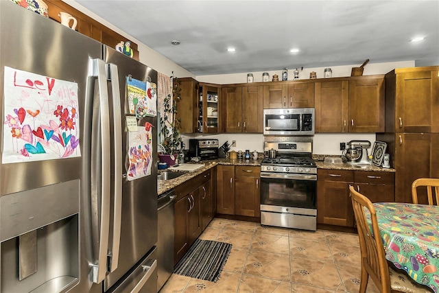 1150 Langdon St, Franklin Square, NY 11010 - kitchen featuring stainless steel appliances, dark stone countertops, light tile patterned floors, glass insert cabinets, and recessed lighting