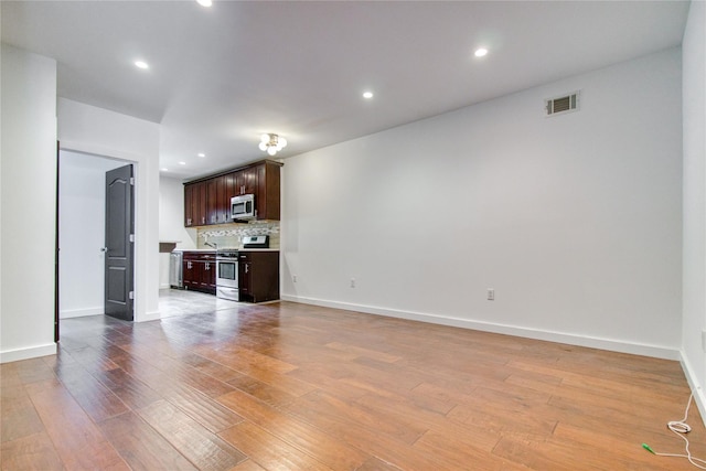 151 Noll St, Brooklyn, NY 11206 - unfurnished living room with light wood-style flooring, baseboards, and recessed lighting