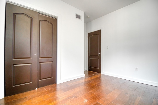 151 Noll St, Brooklyn, NY 11206 - unfurnished bedroom featuring light wood-style flooring, a closet, and baseboards