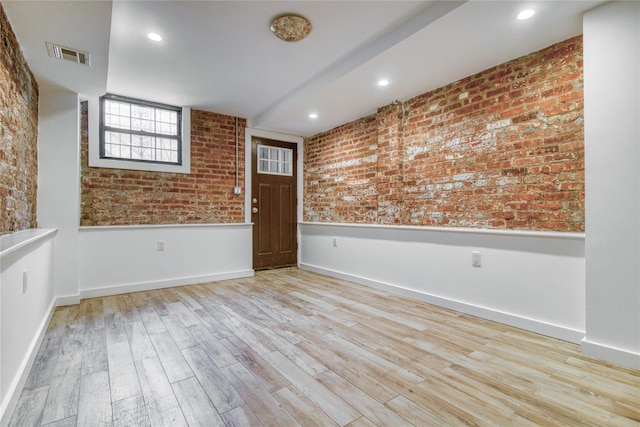 151 Noll St, Brooklyn, NY 11206 - unfurnished room featuring wood finished floors, brick wall, a wainscoted wall, and baseboards
