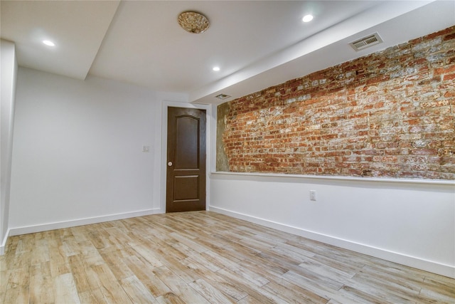 151 Noll St, Brooklyn, NY 11206 - empty room featuring wood finished floors, baseboards, brick wall, and recessed lighting