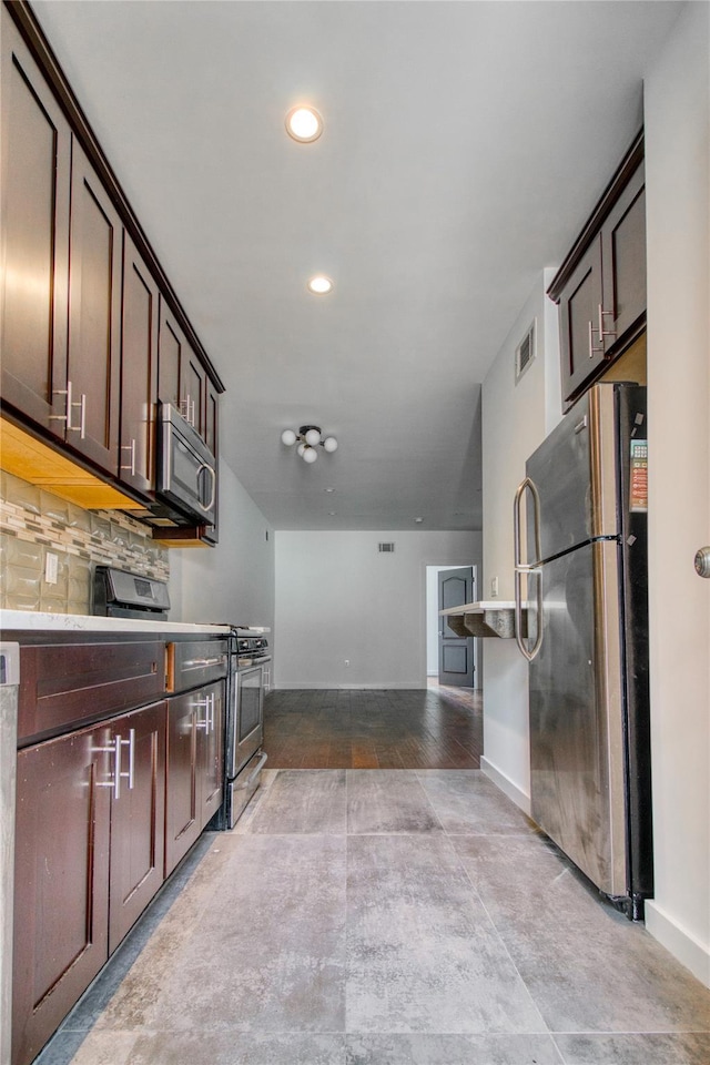151 Noll St, Brooklyn, NY 11206 - kitchen with appliances with stainless steel finishes, dark brown cabinets, baseboards, backsplash, and recessed lighting
