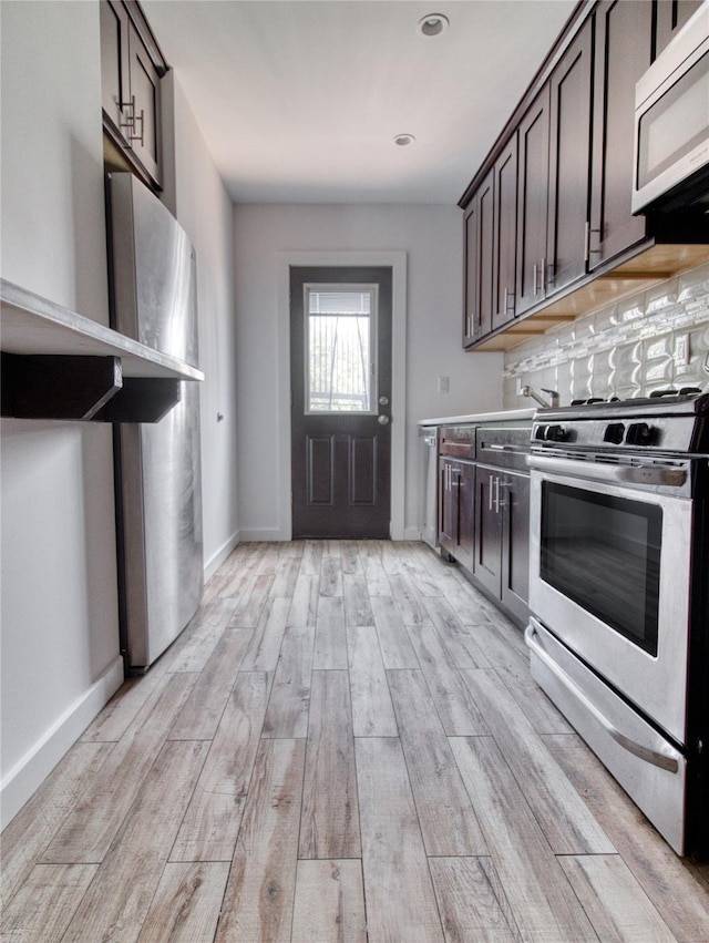151 Noll St, Brooklyn, NY 11206 - kitchen with appliances with stainless steel finishes, dark brown cabinetry, light wood-type flooring, baseboards, and light countertops