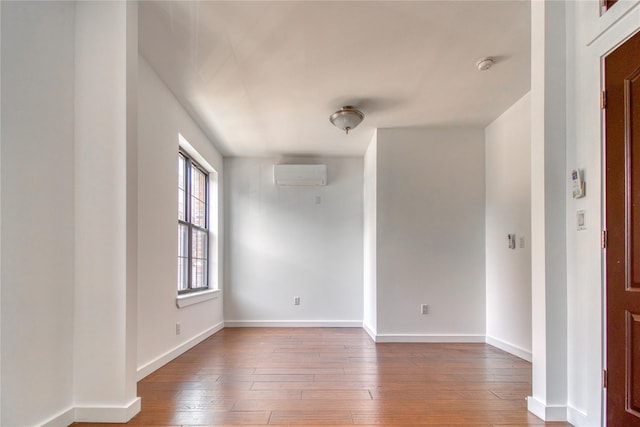 151 Noll St, Brooklyn, NY 11206 - spare room featuring a wall unit AC, hardwood / wood-style floors, baseboards, and a smoke detector