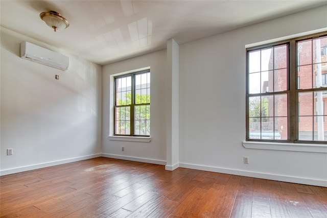 151 Noll St, Brooklyn, NY 11206 - unfurnished room with a wall mounted air conditioner, wood-type flooring, and baseboards