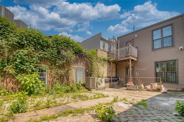 151 Noll St, Brooklyn, NY 11206 - rear view of house featuring a balcony, a patio area, and cooling unit